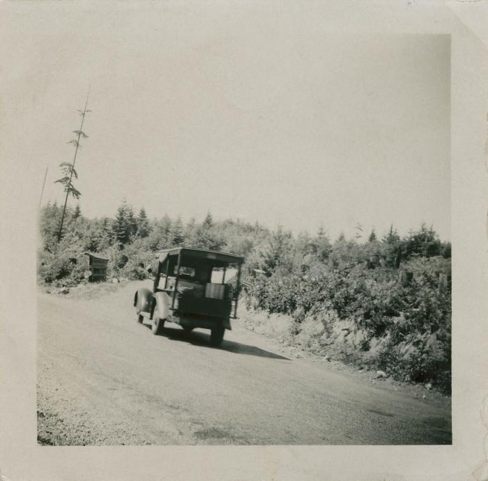 [Truck driving down dirt road]