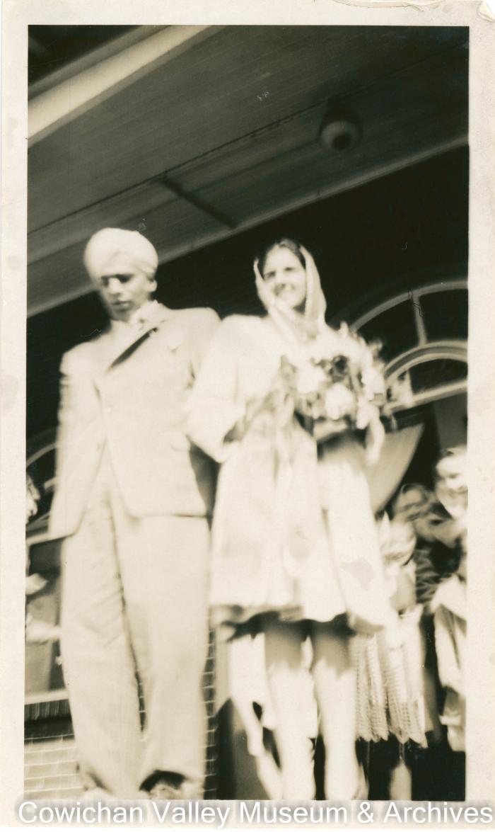 [A couple exiting a building together]