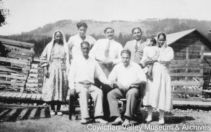Family group : Mrs. Mayo holding child, Hill 60 in background