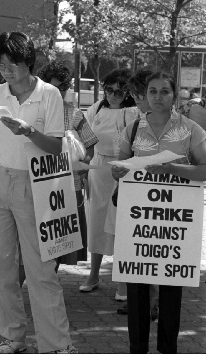 [Group photo of South Asian hospitality union members during strike against Toigo's White Spot]