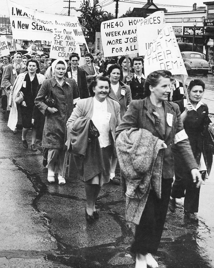 [Photo of IWA members during a protest]