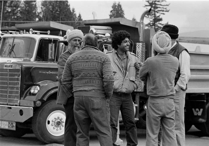 [Photo of South Asian truckers and independent owner-operators at the protest convoy]