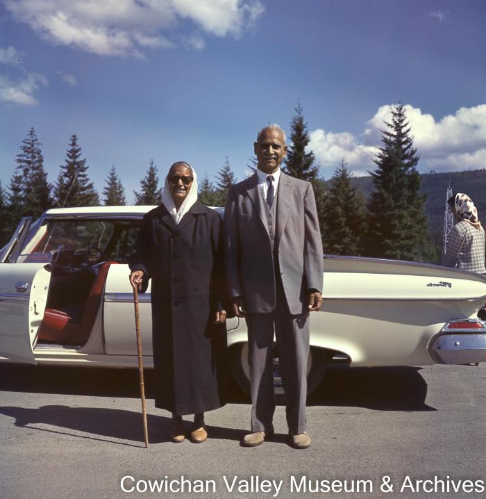 [Kapoor Singh and Basant Kour posing in front of beige car]