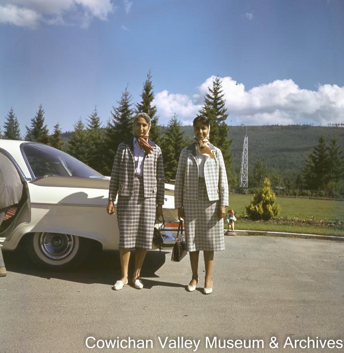 [Kapoor sisters standing near a car]
