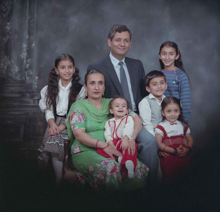 [Group portrait of Paul Gill, an unidentified woman and five unidentified children]