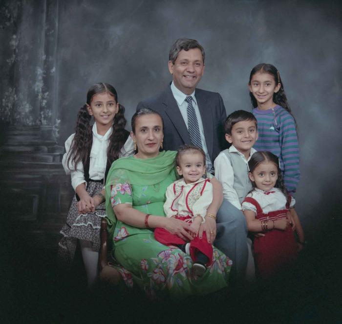 [Group portrait of Paul Gill, an unidentified woman and five unidentified children]