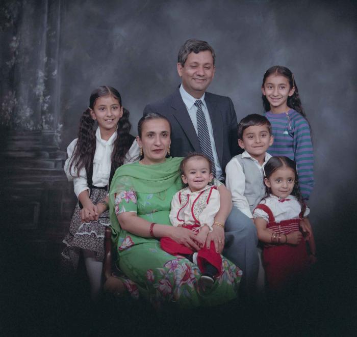 [Group portrait of Paul Gill, an unidentified woman and five unidentified children]