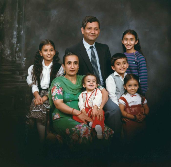 [Group portrait of Paul Gill, an unidentified woman and five unidentified children]