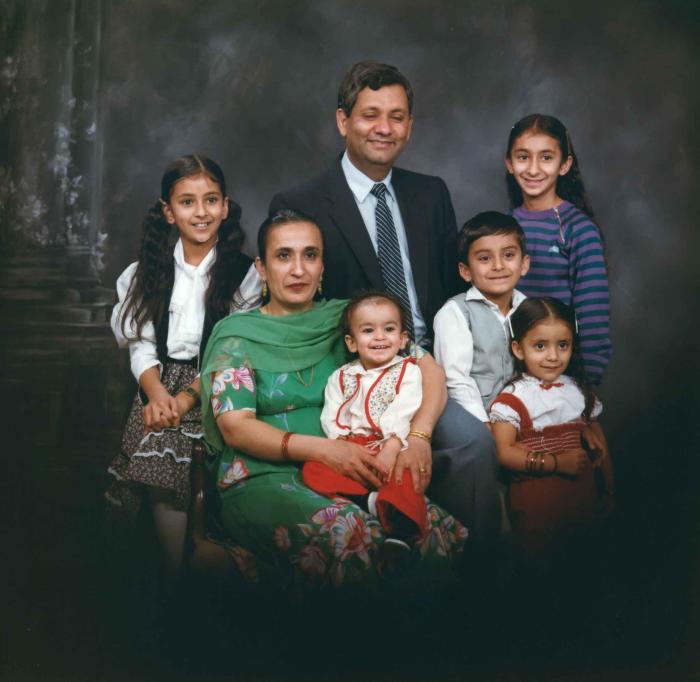 [Group portrait of Paul Gill, an unidentified woman and five unidentified children]