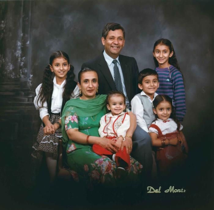 [Group portrait of Paul Gill, an unidentified woman and five unidentified children]