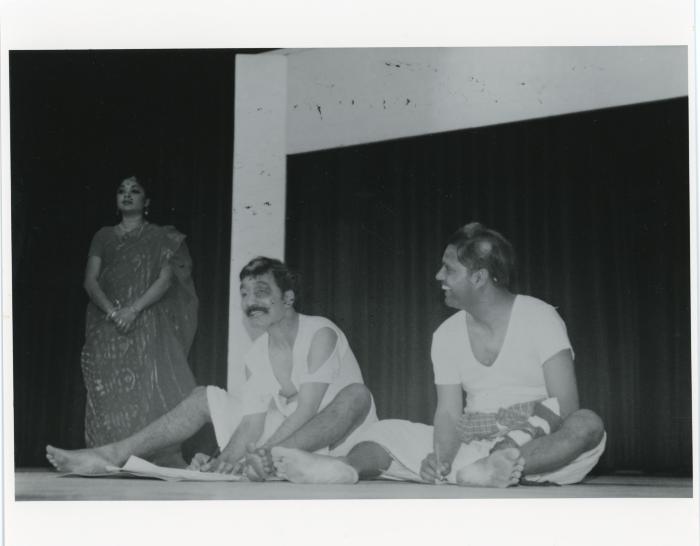 [Photo of theatre artists on a stage]