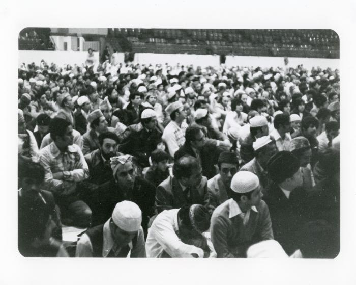 [Photo of a large group of people inside a mosque]