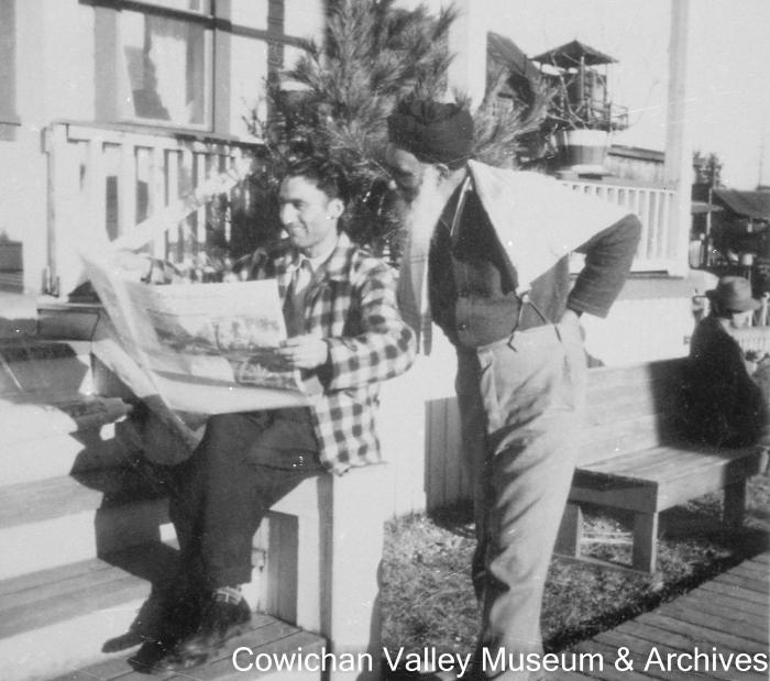 [Atma Singh Dodd reads the New York Times with an unidentified brother of Mayo Singh]