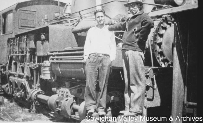 [Atma SIngh Dodd and unidentified office employee standing on locomotive]