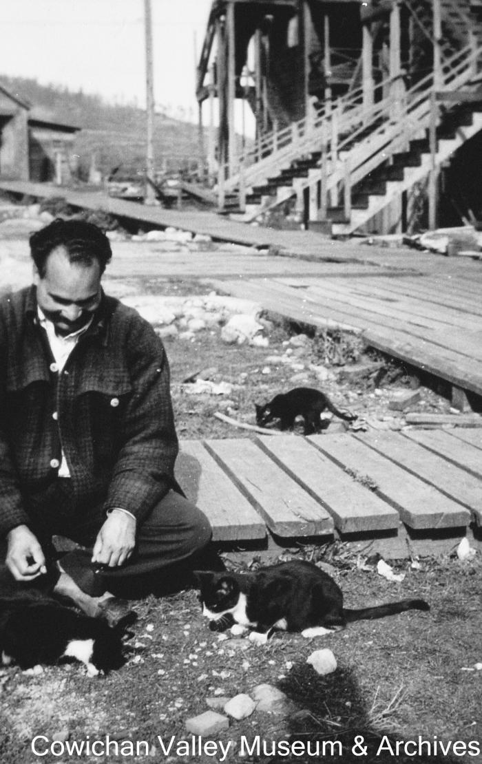 [Kishen Singh Parhar feeding two cats in Paldi]