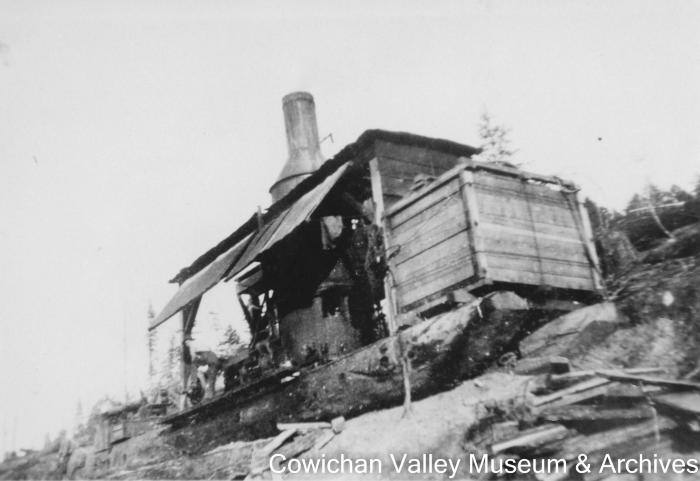 [A donkey engine on a lumber yard]
